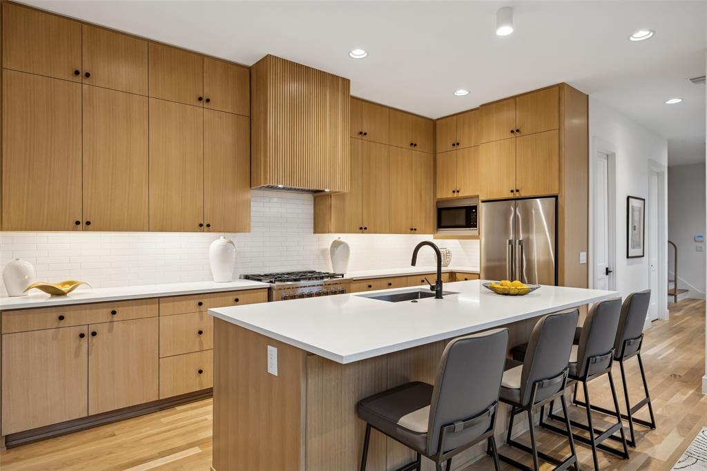 5600 Ellsworth Avenue Dallas, TX 75206 - Photo 6 of 31 a kitchen with a sink stove and refrigerator