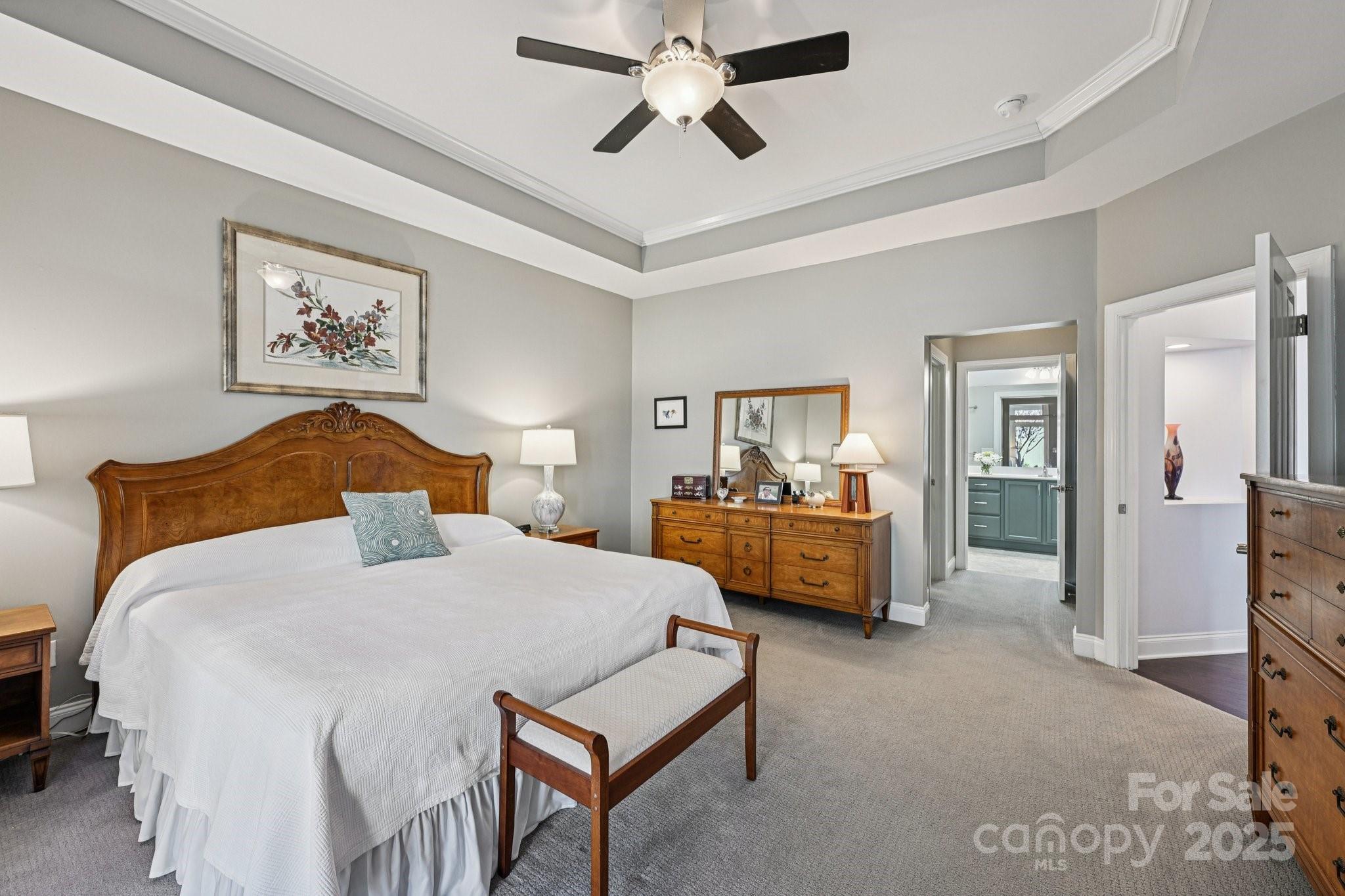 1293 Restoration Drive Waxhaw, NC 28173 - Photo 15 of 41 a bedroom with a bed and a chandelier