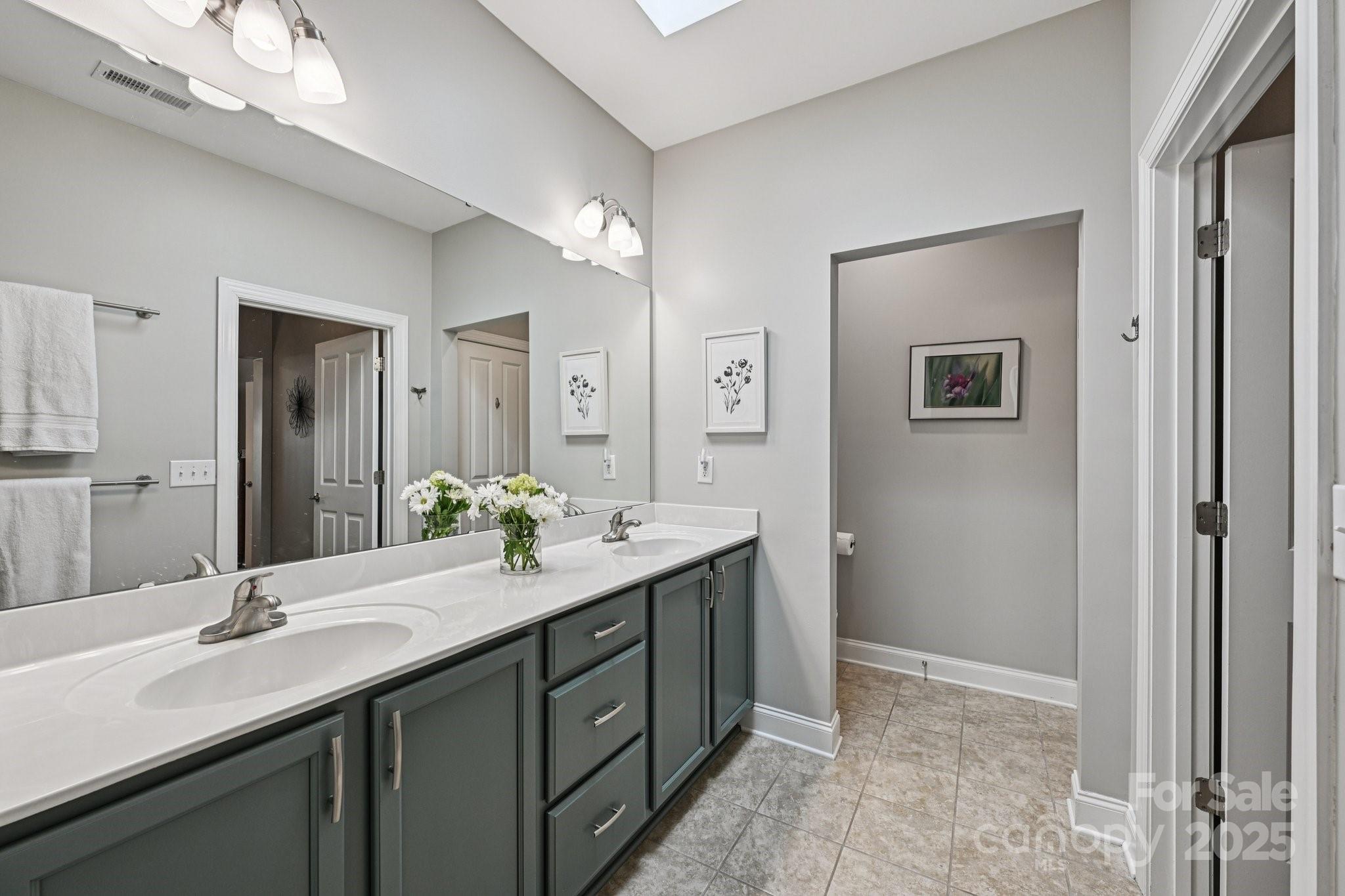 1293 Restoration Drive Waxhaw, NC 28173 - Photo 19 of 41 a bathroom with a double vanity sink and a mirror