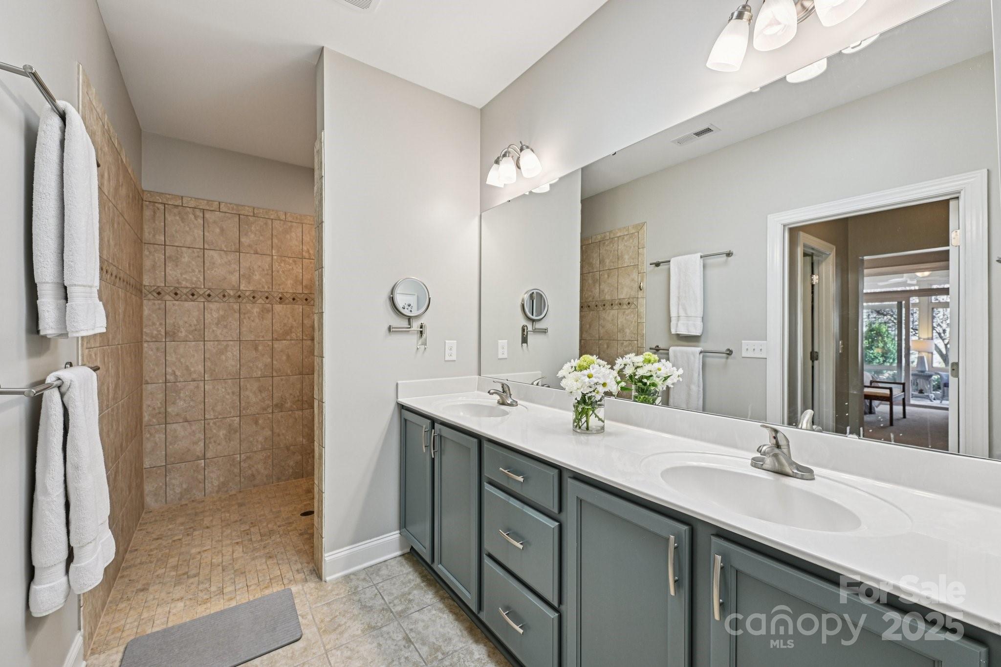 1293 Restoration Drive Waxhaw, NC 28173 - Photo 20 of 41 a bathroom with a double vanity sink mirror and shower
