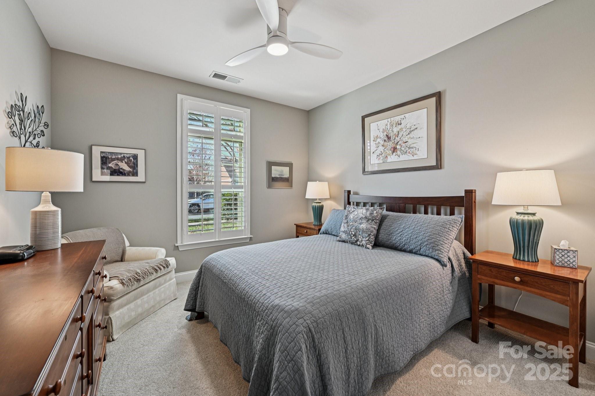 1293 Restoration Drive Waxhaw, NC 28173 - Photo 24 of 41 a bedroom with a bed and a lamp on dresser