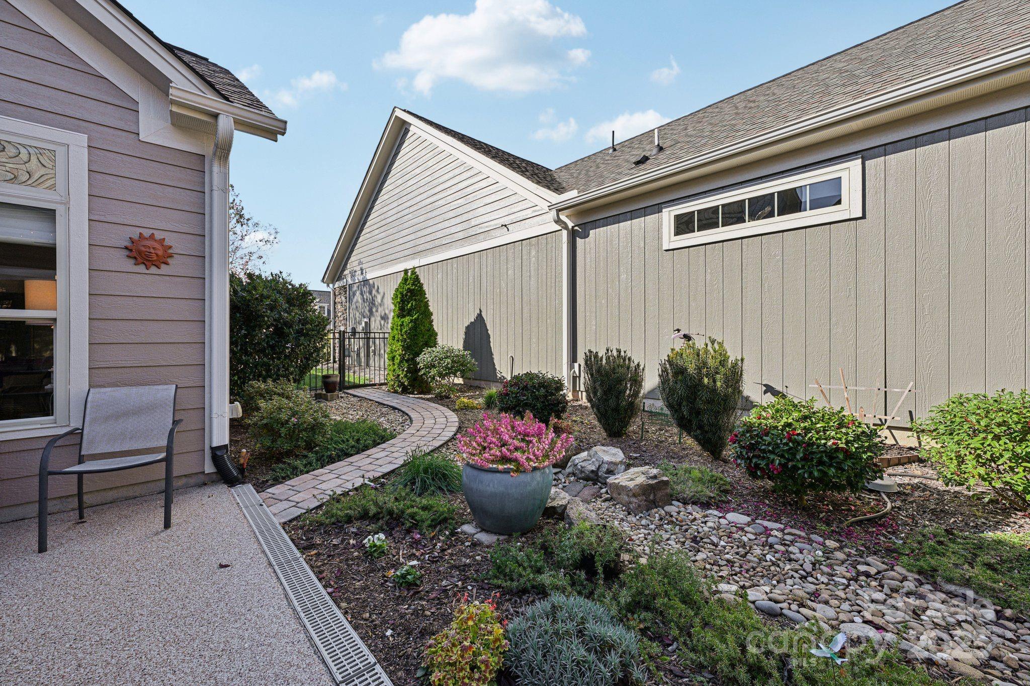 1293 Restoration Drive Waxhaw, NC 28173 - Photo 29 of 41 a view of a backyard with chair and potted plants