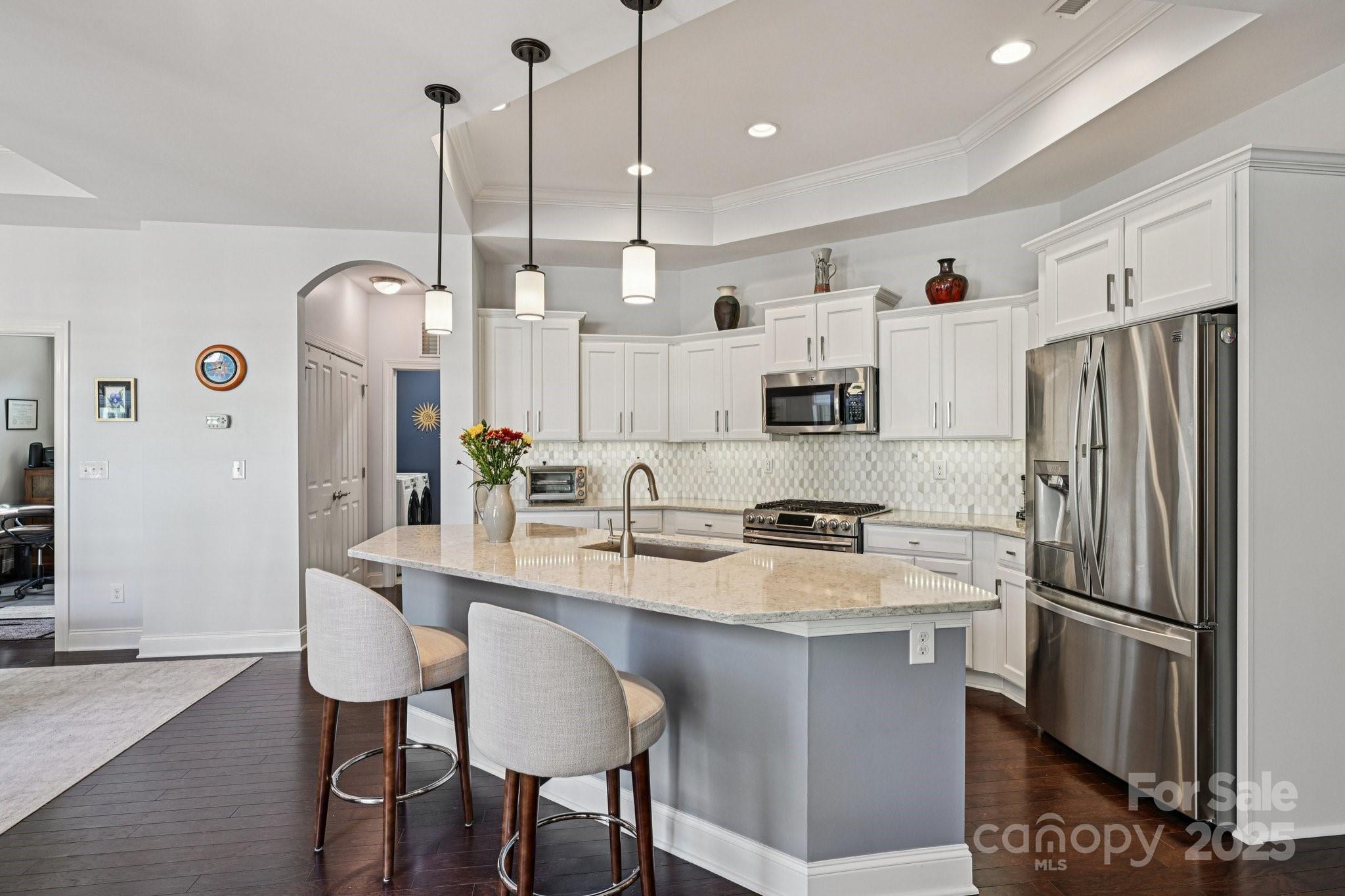 1293 Restoration Drive Waxhaw, NC 28173 - Photo 8 of 41 a kitchen with refrigerator a sink and chairs