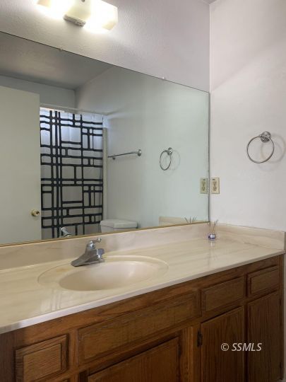 345 South Fountain Street Ridgecrest, CA 93555 - Photo 11 of 24 a bathroom with a sink and a mirror