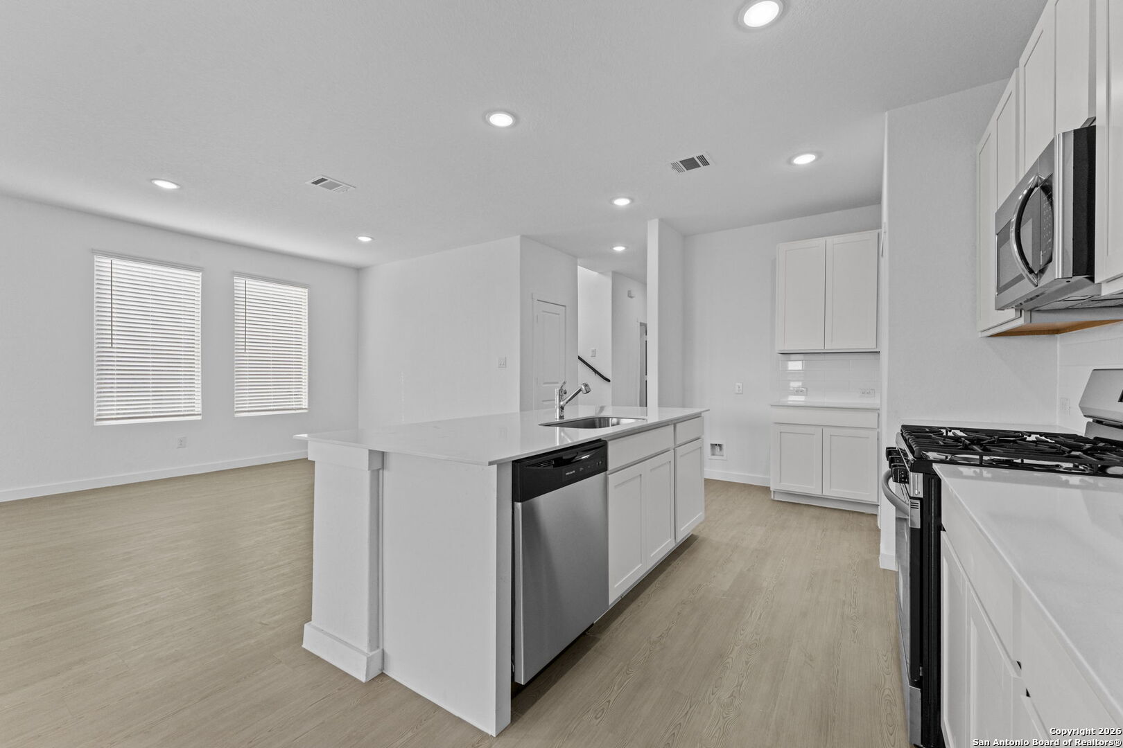 1859 Nuthatch Ridge New Braunfels, TX 78130 - Photo 12 of 34 a large kitchen with stainless steel appliances granite countertop a stove a sink and a refrigerator