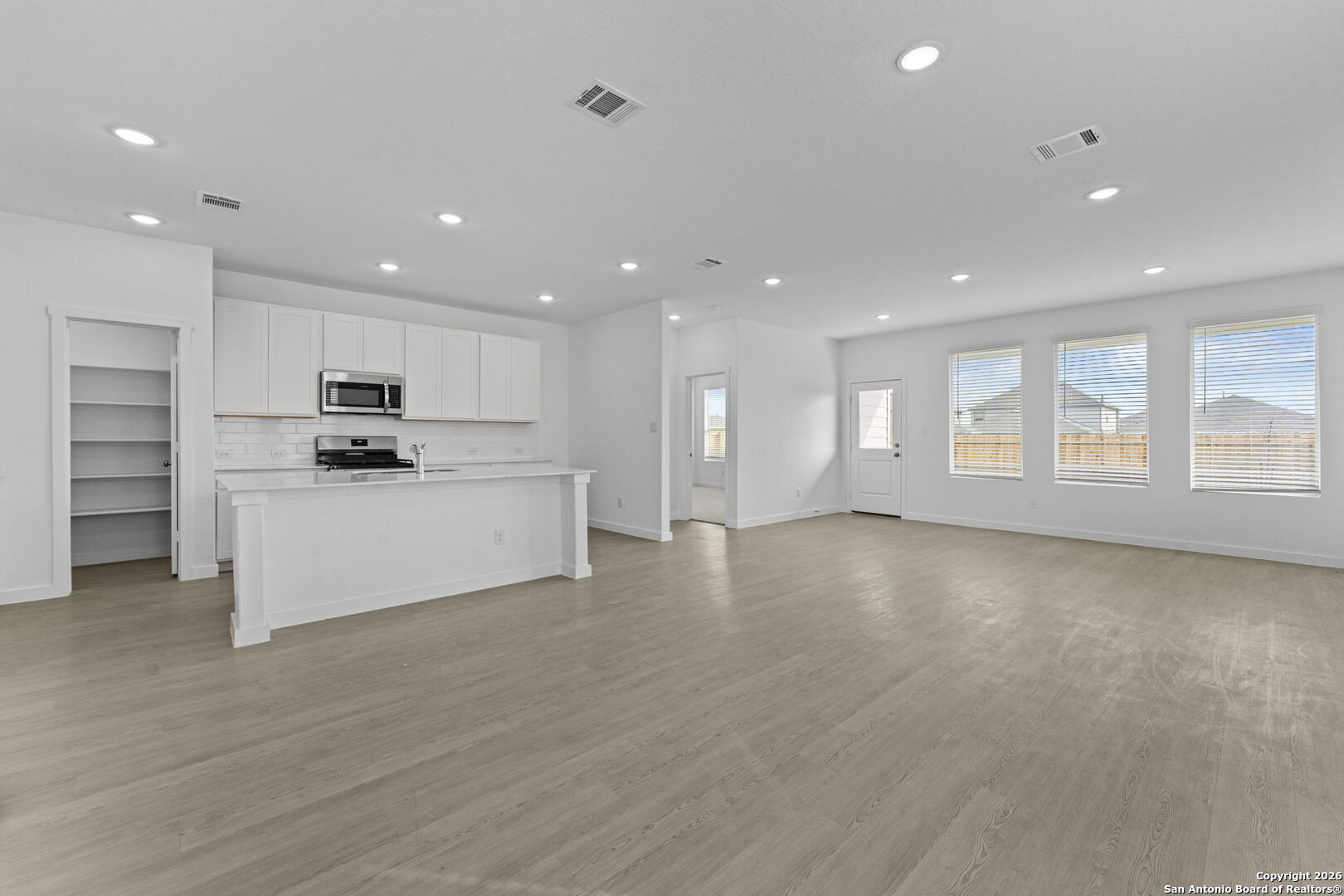 1859 Nuthatch Ridge New Braunfels, TX 78130 - Photo 14 of 34 a view of an empty room with kitchen and window