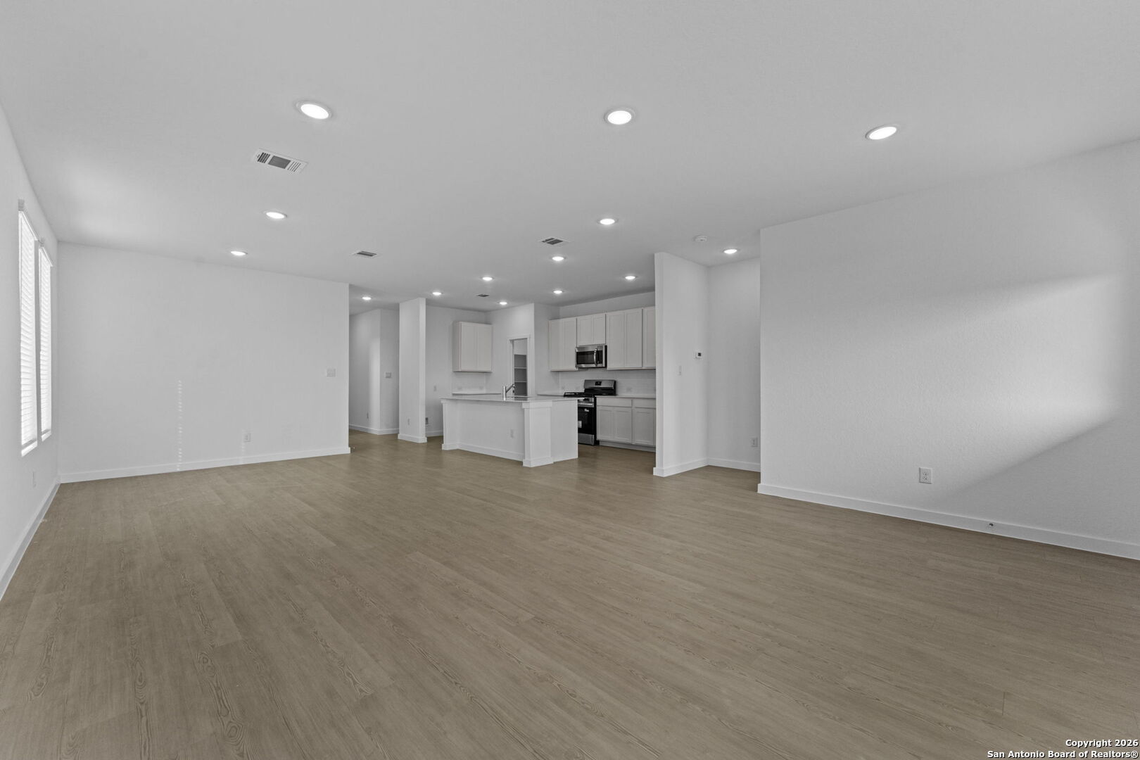 1859 Nuthatch Ridge New Braunfels, TX 78130 - Photo 16 of 34 a view of an empty room with a kitchen