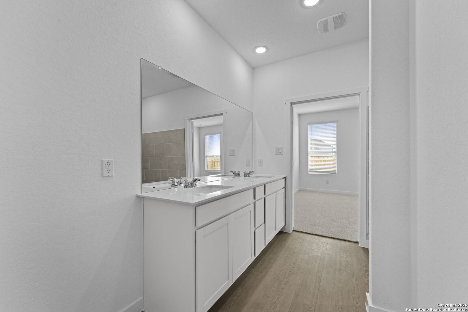 1859 Nuthatch Ridge New Braunfels, TX 78130 - Photo 20 of 34 a bathroom with a sink a toilet and mirror