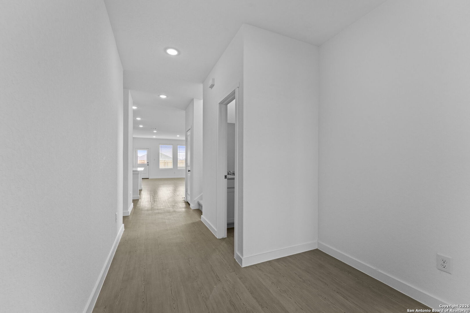 1859 Nuthatch Ridge New Braunfels, TX 78130 - Photo 2 of 34 a view of a hallway with wooden floor