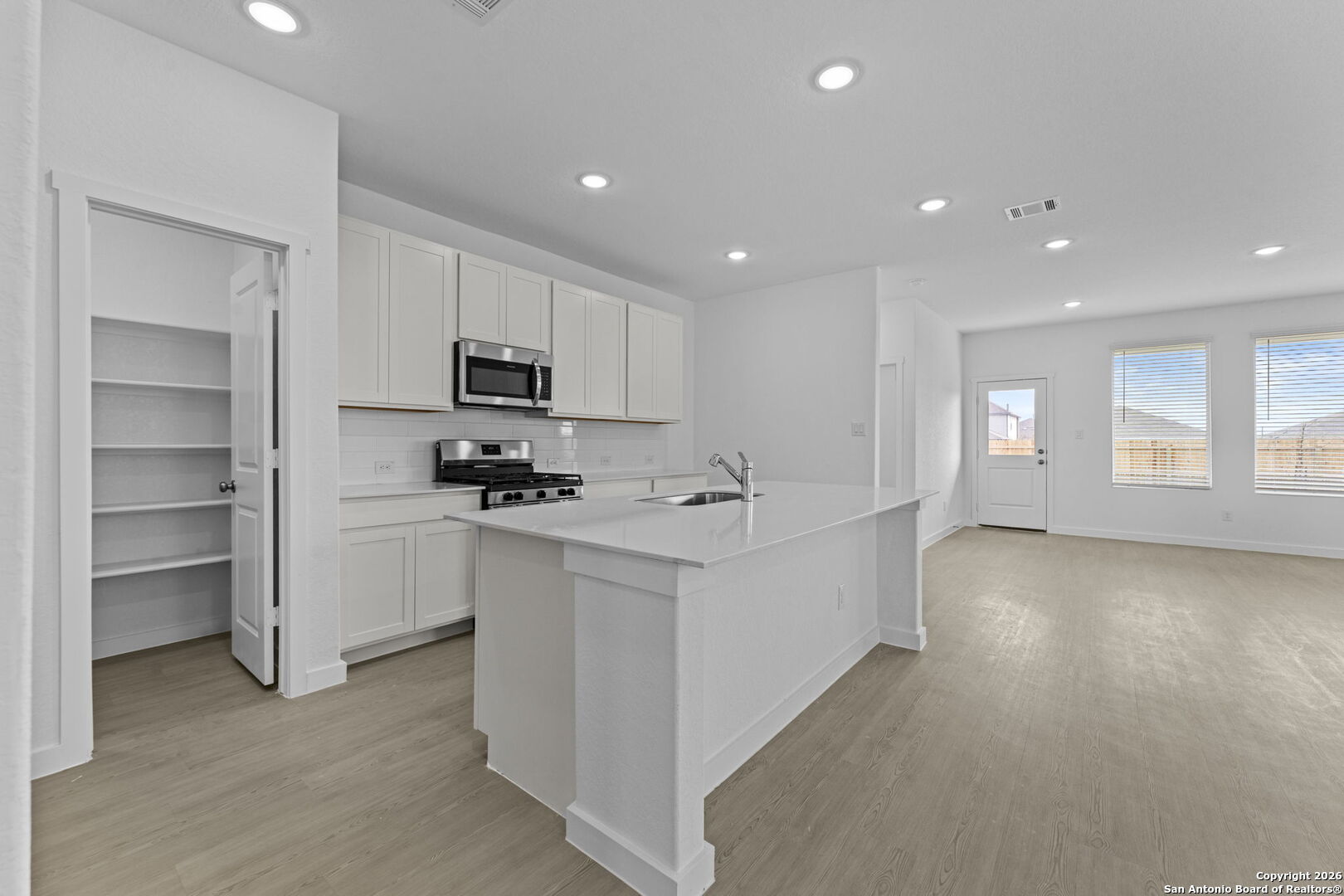 1859 Nuthatch Ridge New Braunfels, TX 78130 - Photo 10 of 34 a kitchen with stainless steel appliances granite countertop a stove a sink and a refrigerator