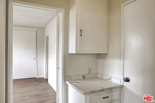 a view of a kitchen cabinets a sink and dishwasher in a white cabinet