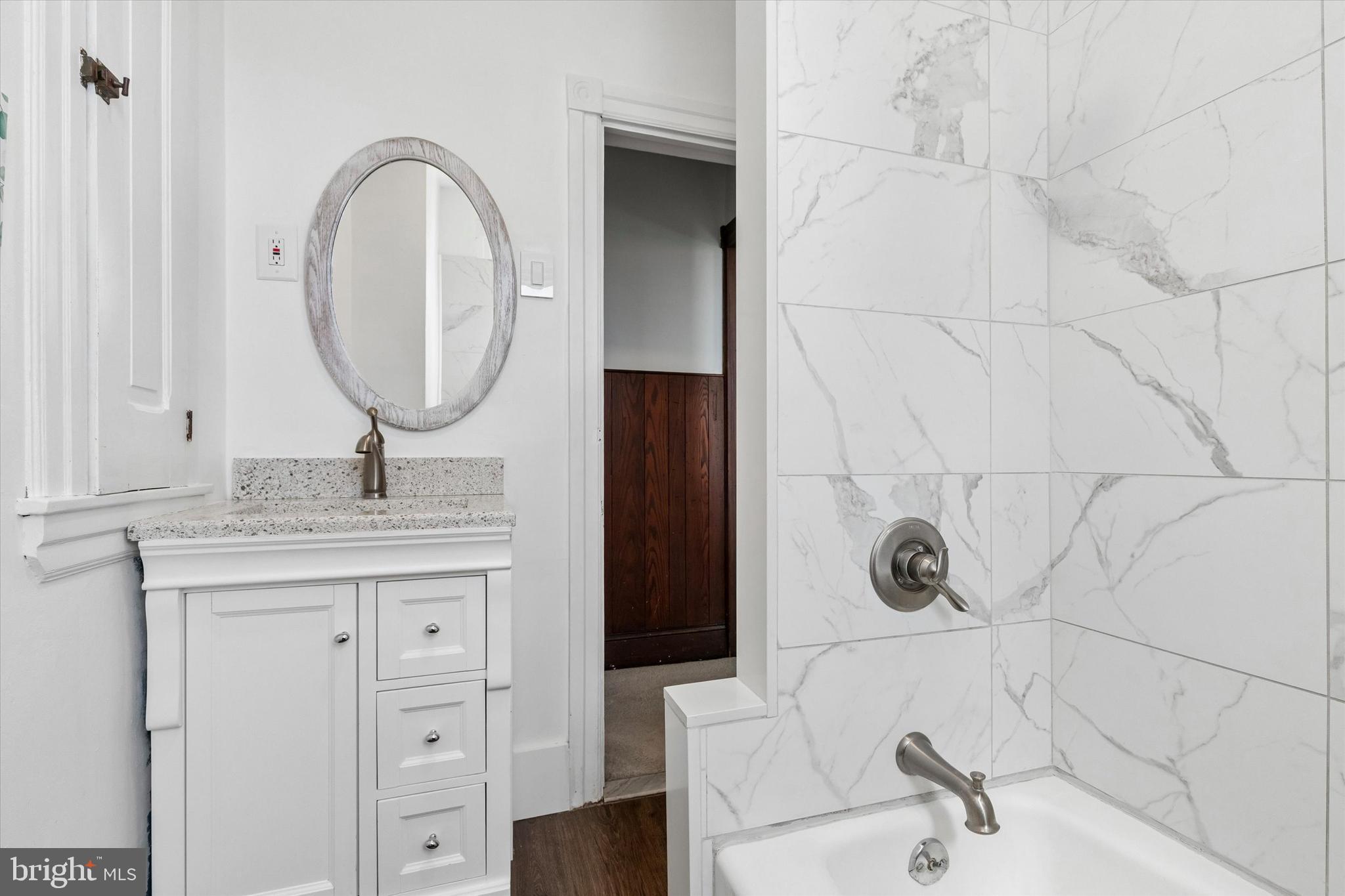 35 North Ridge Avenue Ambler, PA 19002 - Photo 12 of 15 a bathroom with a granite countertop sink a mirror and shower
