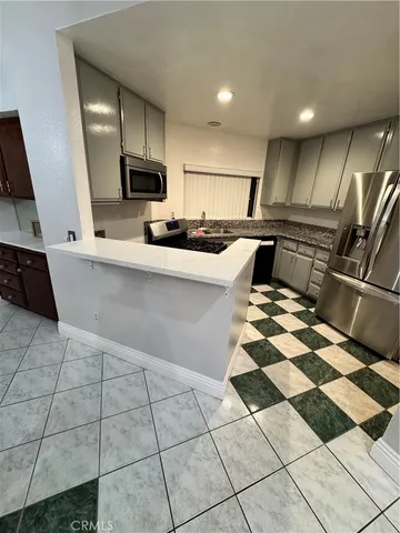 a kitchen with stainless steel appliances granite countertop a sink and cabinets