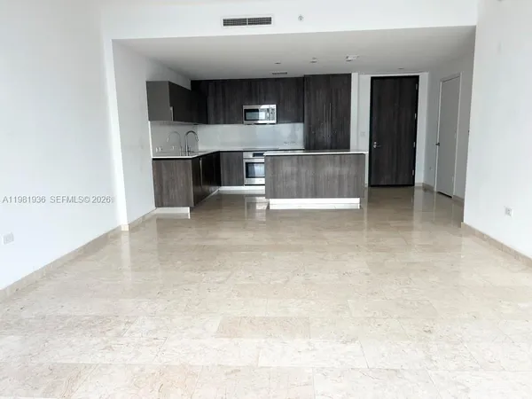 a view of kitchen and refrigerator