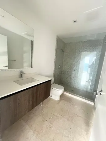 a bathroom with a bathtub sink and mirror