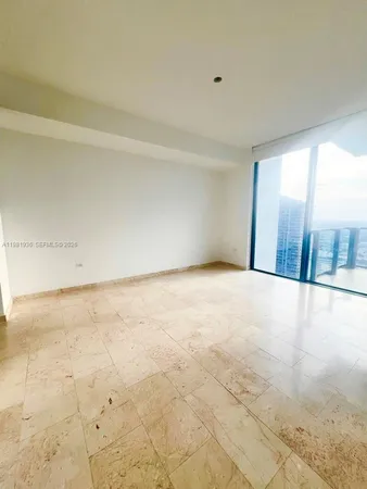 an empty room with floor to ceiling window