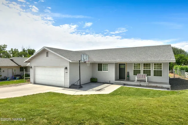 a front view of a house with yard and glass windows