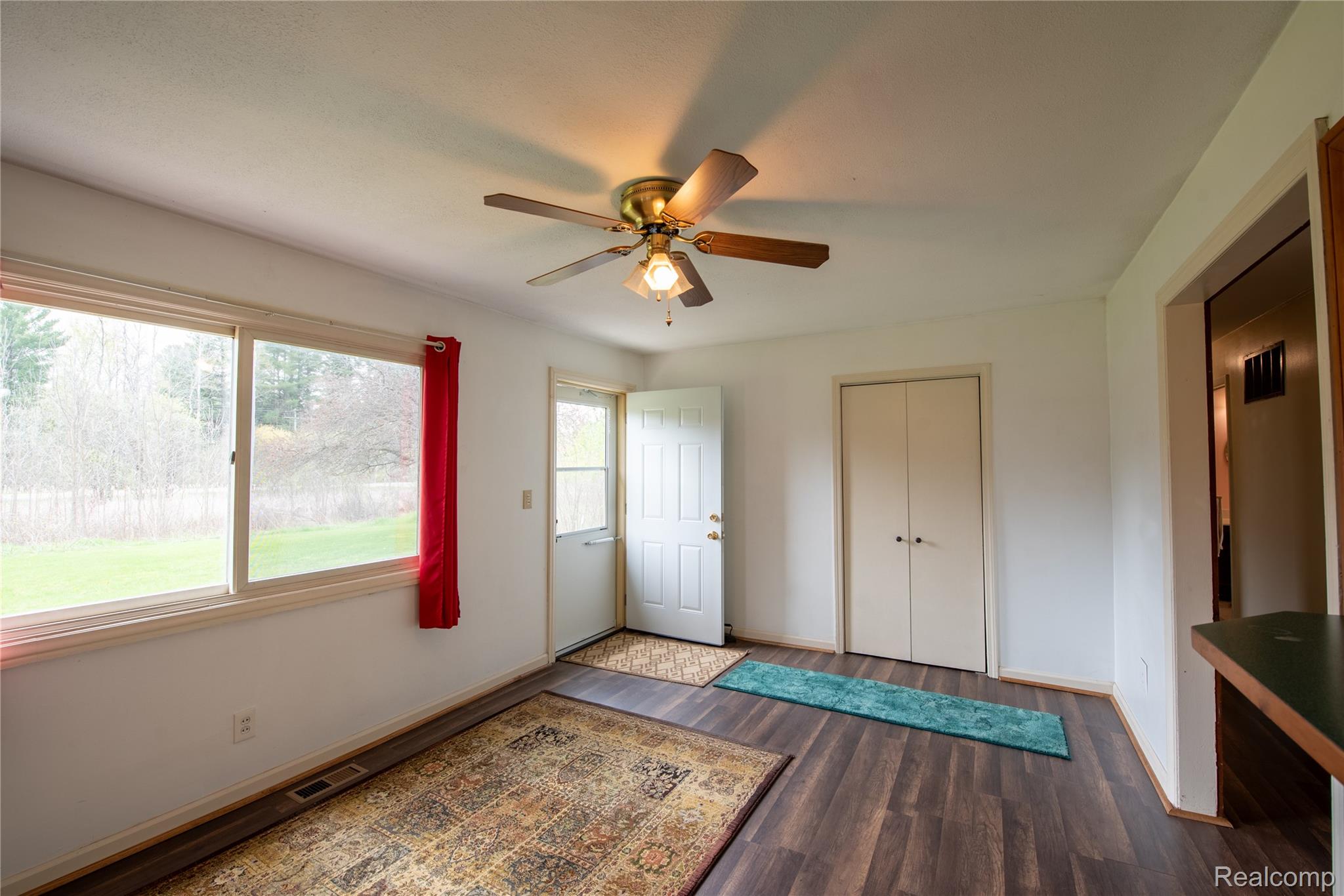 1190 Meadow Road Tawas City, MI 48763 - Photo 10 of 26 Foyer entrance with dark wood-type flooring and a ceiling fan