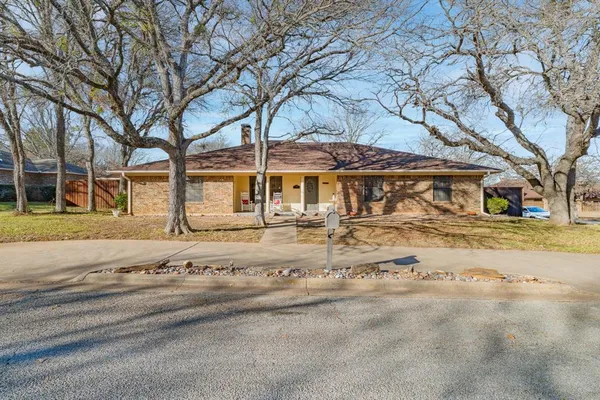 front view of a house with a dry trees