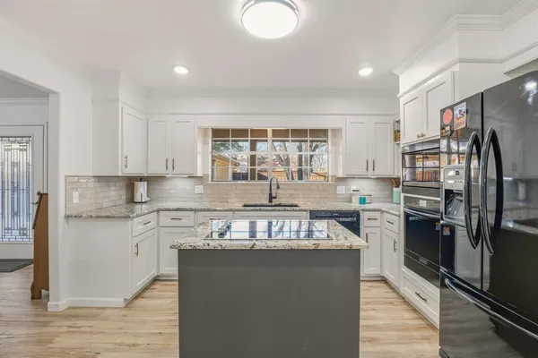 a kitchen with a refrigerator and a sink