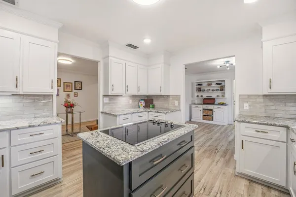 a kitchen with granite countertop a sink and cabinets