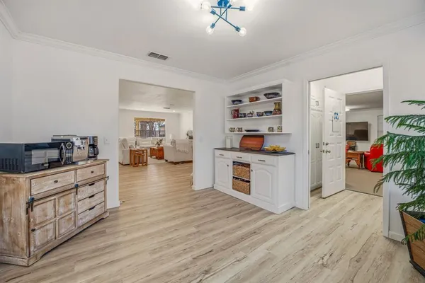 a kitchen with stainless steel appliances wooden floor and stove top oven