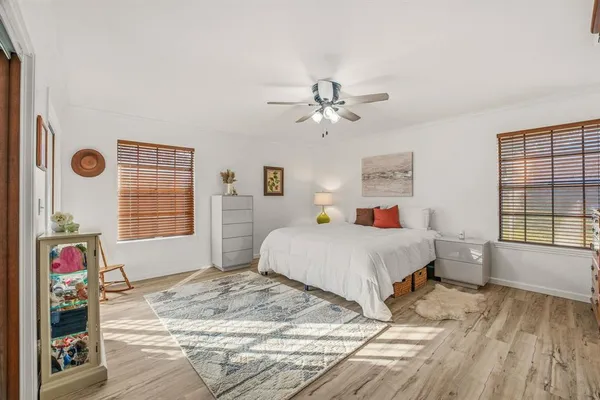 a spacious bedroom with a bed and a window
