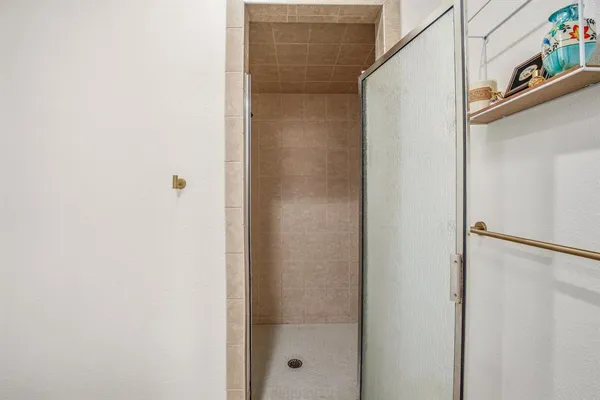 a bathroom with a glass shower door