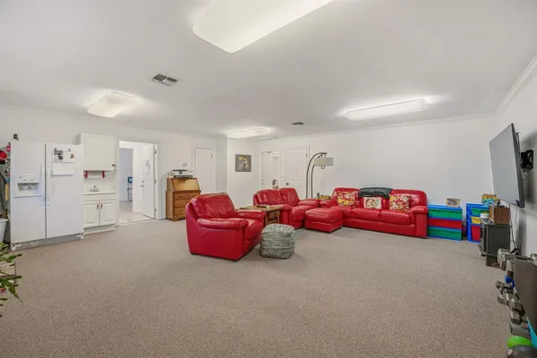 a living room with lots of furniture and clutter