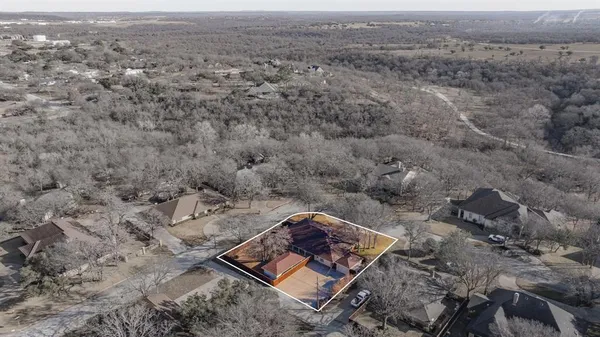 an aerial view of a house with a yard