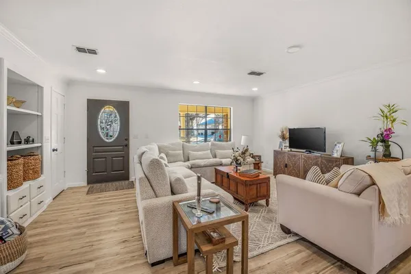 a living room with furniture a rug and a flat screen tv