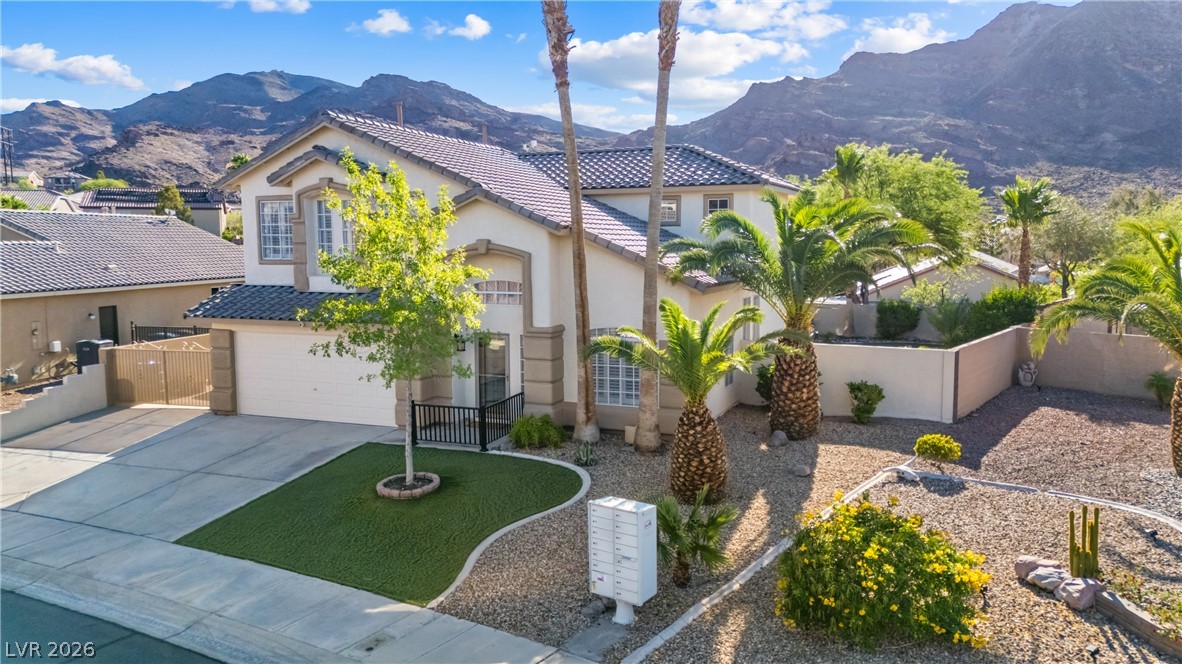 708 Vortex Avenue Henderson, NV 89002 - Photo 52 of 71 A desert oasis home with mountains as a backdrop offers a welcoming entry and low-maintenance landscaping.