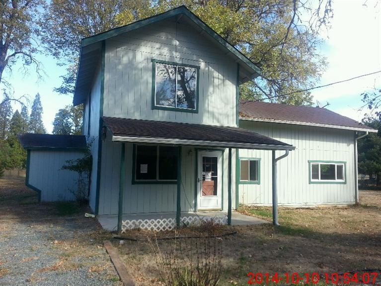 230 Hummingbird Road Cave Junction, OR 97523 - Photo 1 of 10 a front view of a house with a yard