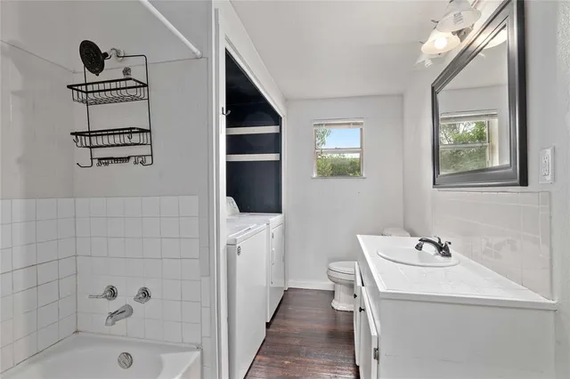 a bathroom with a bathtub sink and mirror