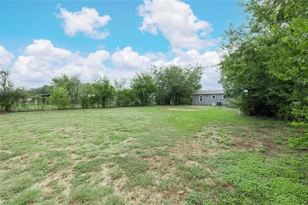 a backyard of a house with lots of green space