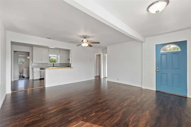 a view of a kitchen with wooden floor and a kitchen