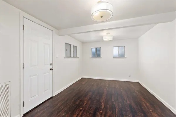 a view of a room with wooden floor