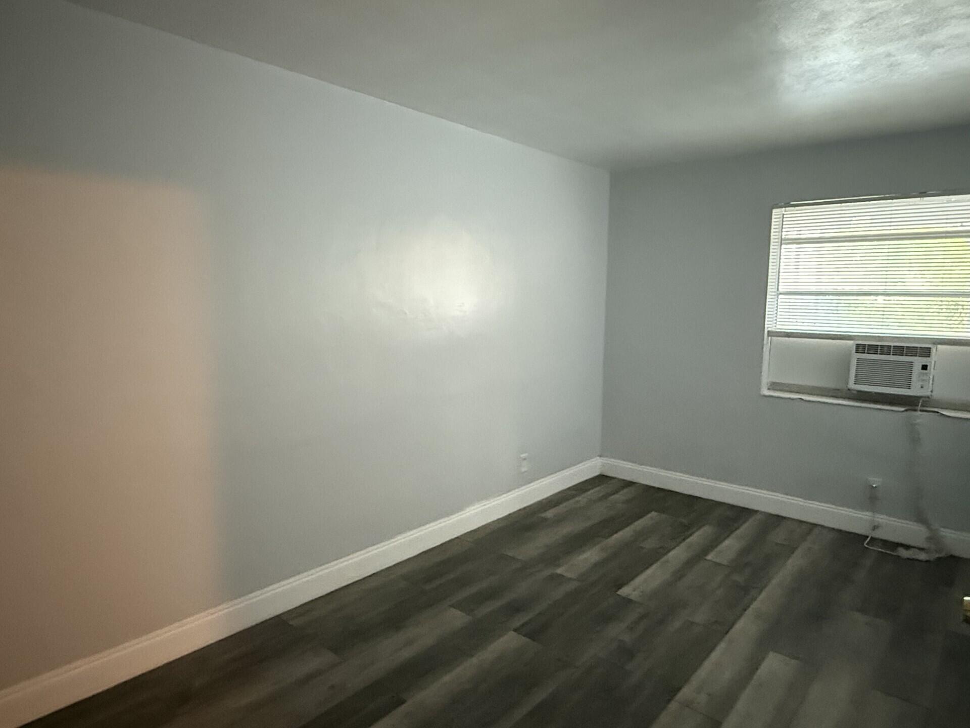 131 East 27th Street, Unit 4 Riviera Beach, FL 33404 - Photo 2 of 10 wooden floor in an empty room