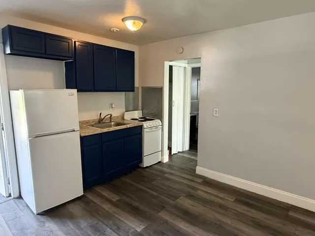 a kitchen with a refrigerator and a stove