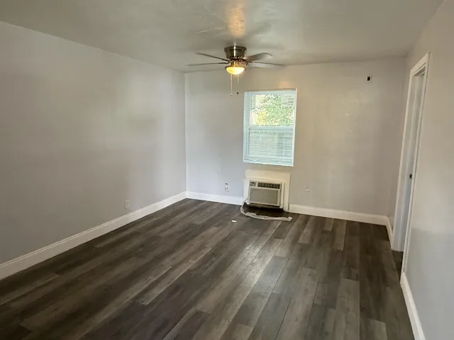 wooden floor in an empty room with a window