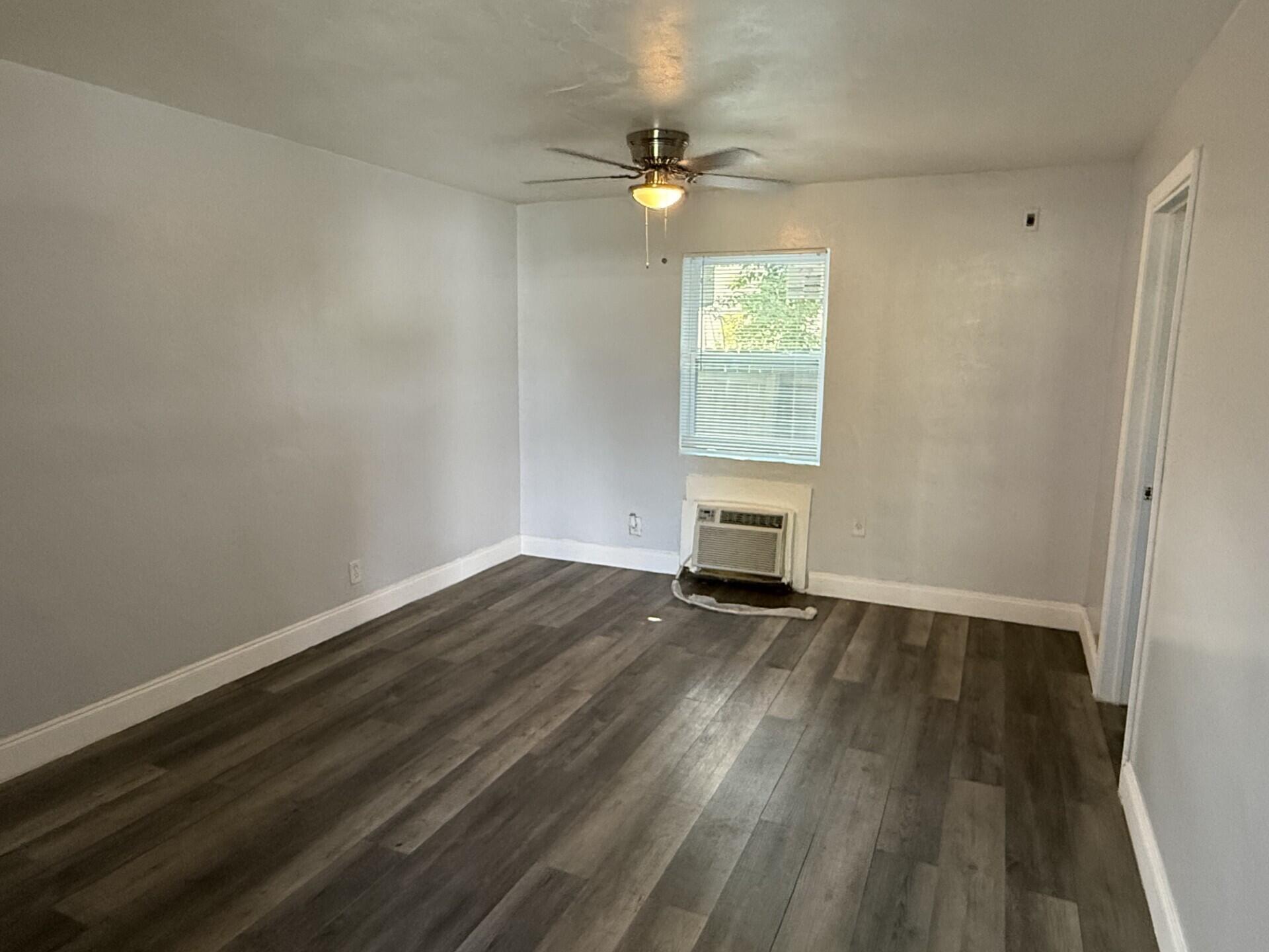 131 East 27th Street, Unit 4 Riviera Beach, FL 33404 - Photo 6 of 10 wooden floor in an empty room with a window