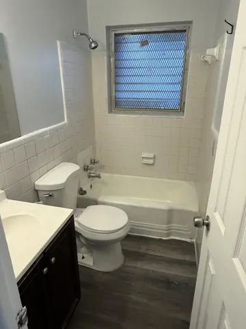 a bathroom with a toilet a sink and bathtub