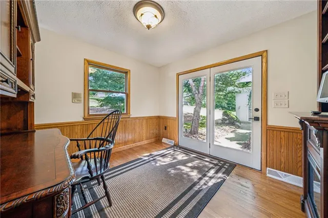 a view of a workspace with furniture and a window