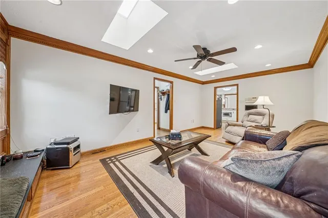 a living room with furniture a ceiling fan and a rug