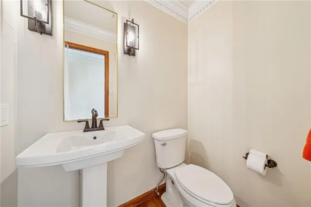 a white toilet sitting next to a bathroom sink