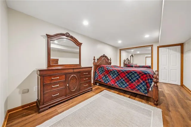 a bedroom with a large bed and a dresser