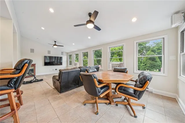 a spacious bathroom with a toilet a sink and a mirror