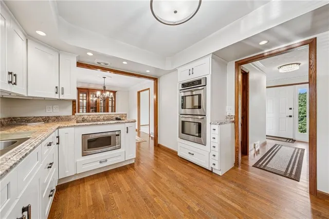 a kitchen with stainless steel appliances a stove top oven and a refrigerator