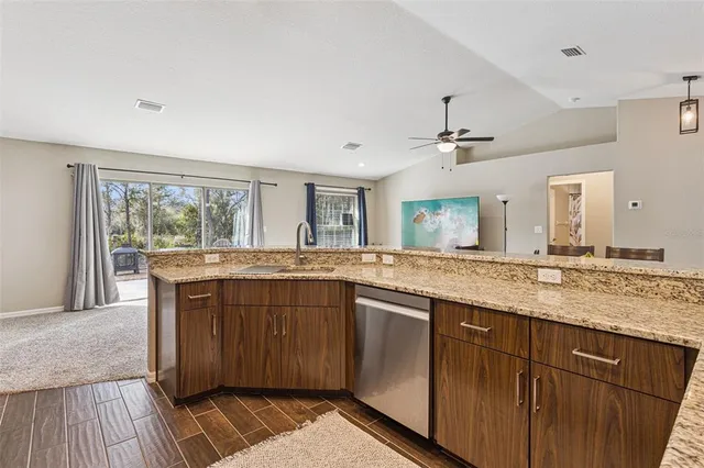 a bathroom with a granite countertop sink and a large mirror