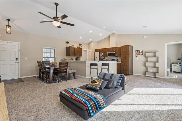 a bed room with furniture and kitchen view